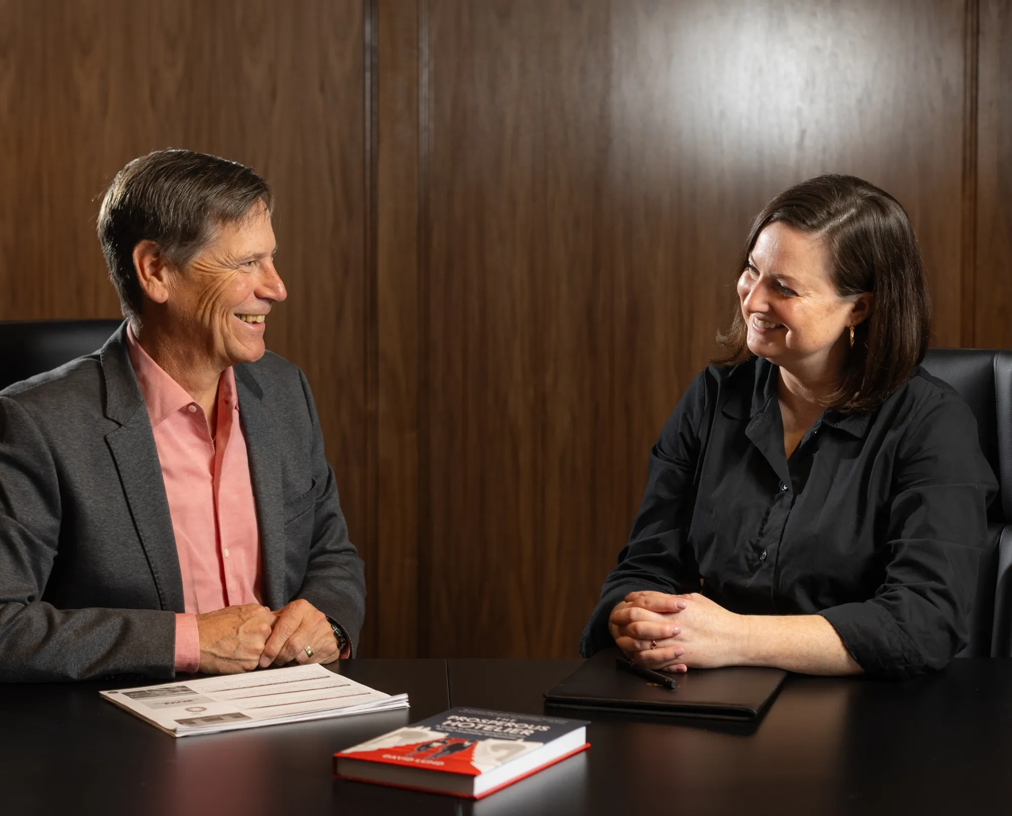 David Lund at office desk consulting a female client