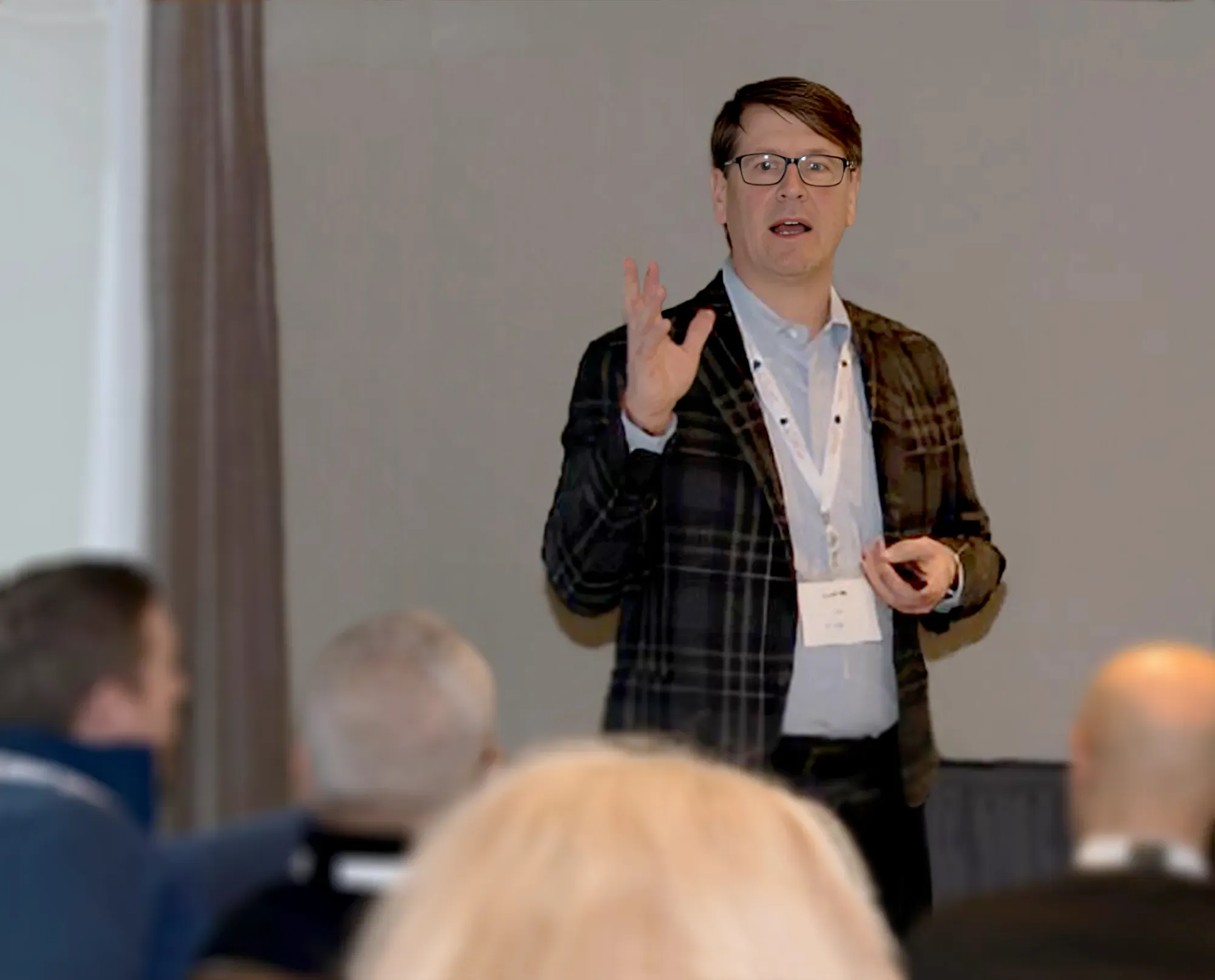 David Lund speaking in front of several people